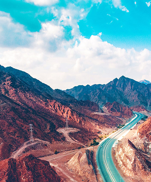 Road winding through red colored mountains.