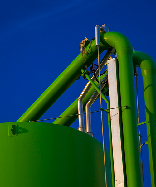 Green industrial storage tanks and pipes.