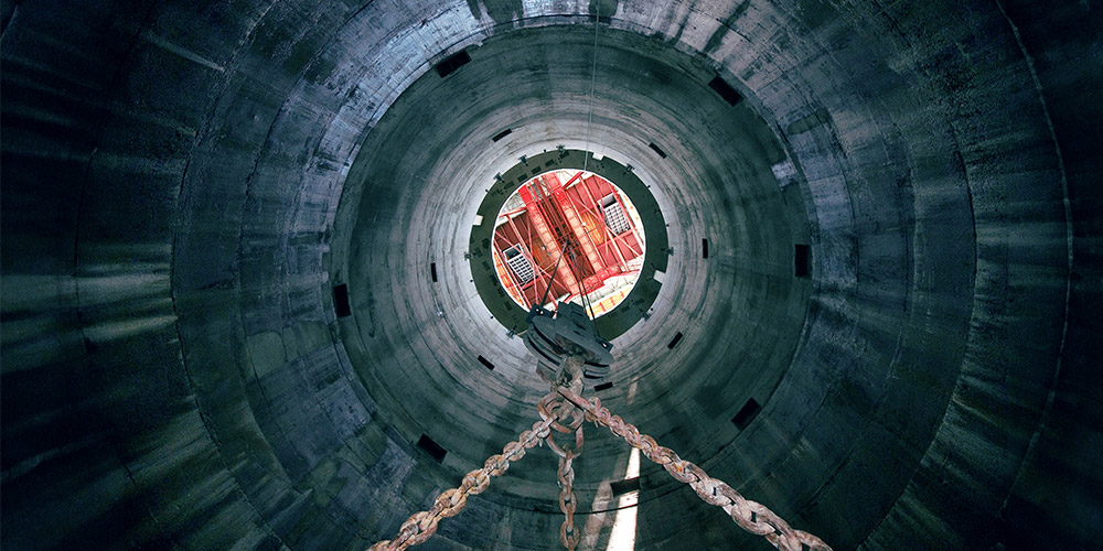 Crane on the inside of a mine shaft.